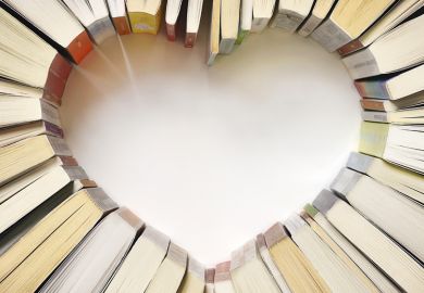 Books arranged on table in shape of heart