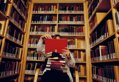 Person reading books in library