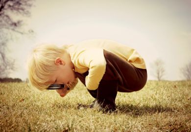 Boy with magnifying glass