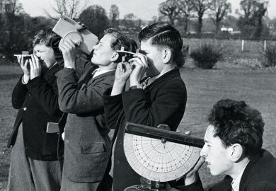 boys practise surveying