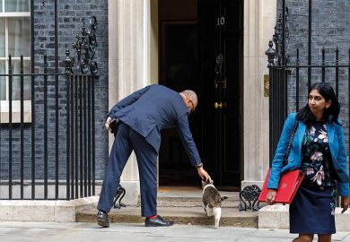Suella Braverman leaves Downing Street as James Cleverly, on his way in, strokes a cat Suella Braverman leaves Downing Street as James Cleverly, on his way in, strokes a cat