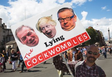 Brexit demonstrator holding sign of Nigel Farage, Boris Johnson and Michael Gove