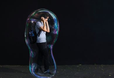 Young man inside giant bubble
