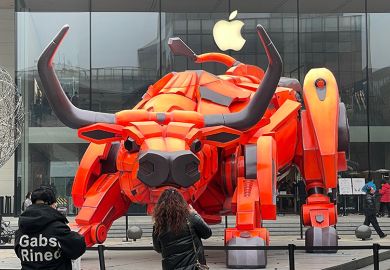 People look at a bull statue set up in front of an Apple store at Sanlitun, 2021 in Beijing, China. To illustrate if the academy can rein in Big Tech. People look at a bull statue set up in front of an Apple store at Sanlitun, 2021 in Beijing, China. To illustrate if the academy can rein in Big Tech.