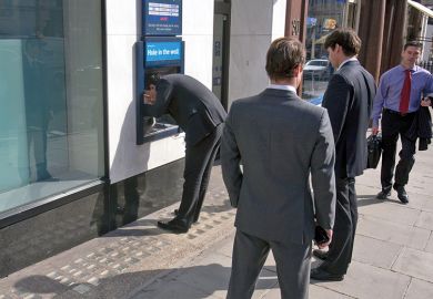 Business men at ATM