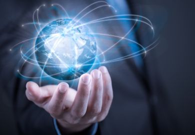 Businessman holding planet Earth in palm