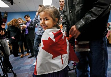 Syrian child wrapped in Canadian flag Syrian child wrapped in Canadian flag