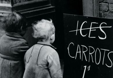 Small children looking at 'Carrots instead of ice lollies' sign Small children looking at 'Carrots instead of ice lollies' sign
