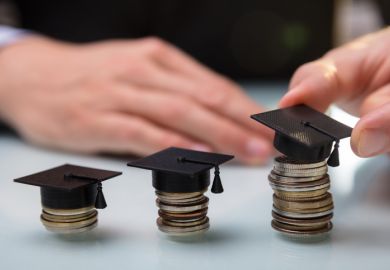 istock coins mortar board Hand Placing Graduation Hat Over Stacked Coins In A Row