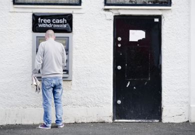 Govan, Glasgow / UK - August 31st 2019: Male person at cash point machine ATM automated free money withdrawal in wall