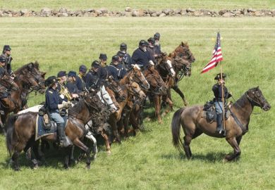 A lone cavalryman backed by numerous others