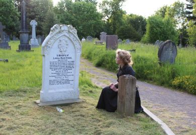 Students perform in a cemetery