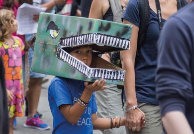 Child in dinosaur costume