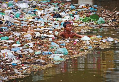 Child swimming in plastic rubbish