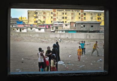 Children playing, viewed through open window, Dharavi, Mumbai