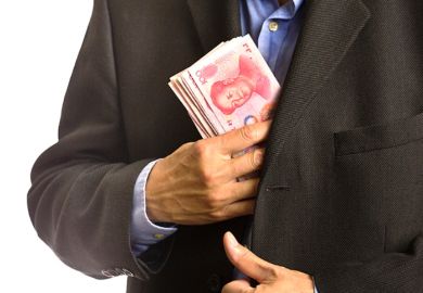 A businessman pocketing Chinese banknotes
