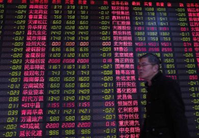 Chinese man by currency exchange board Chinese man by currency exchange board