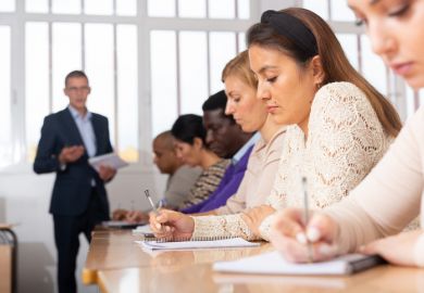 A lecturer looks at a female student in class, illustrating flirtation