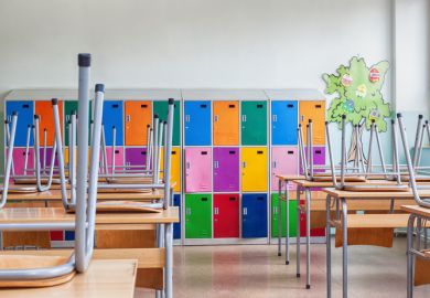 Classroom with colorful lockers and raised chairs on the tables