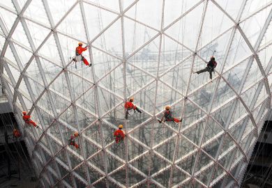 Workers clean the exterior of the Sun Valley pavilion in Shanghai, China