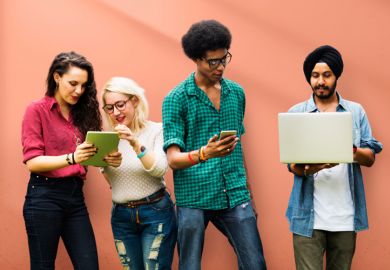 Computer science students working with mobile devices Computer science students working with mobile devices