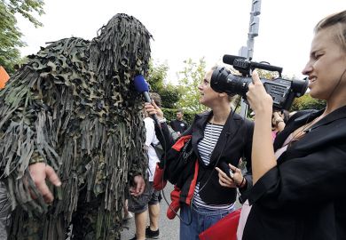 A raver is interviewed by a local TV crew during the 19th annual Techno Street Parade in Zurich