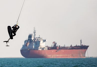 Kite surfer with tanker in the background