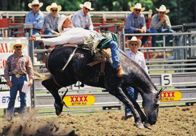 Cowboy riding horse during rodeo, Queensland, Australia