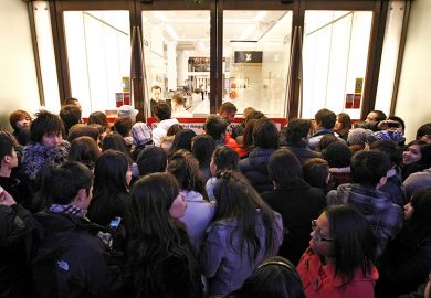 Shoppers wait outside Selfridges as the store opens it doors on the first day of its winter sale on Boxing Day. To illustrate that some universities are enrolling hundreds of research students despite warnings.