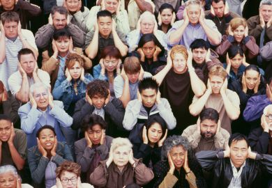 Crowd of people covering ears