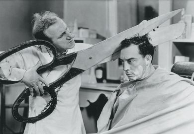 cutting hair with giant scissors