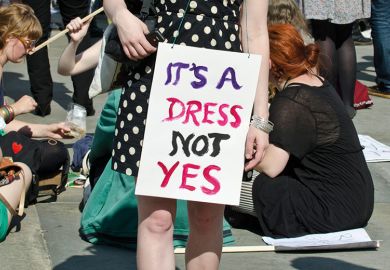 Demonstrator wearing 'It's a dress, not yes' placard Demonstrator wearing 'It's a dress, not yes' placard