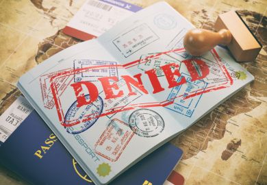 Passport with denied visa stamp on a map of the world Passport with denied visa stamp on a map of the world