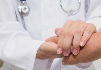 Making it personal Doctor holding hands with patient
