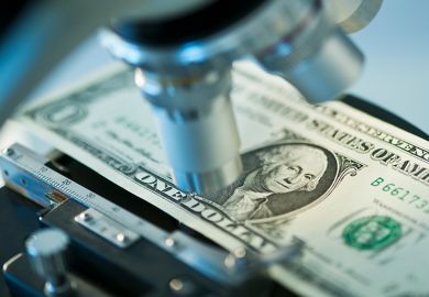 Dollar bill under microscope to illustrate research funding Dollar bill under microscope to illustrate research funding