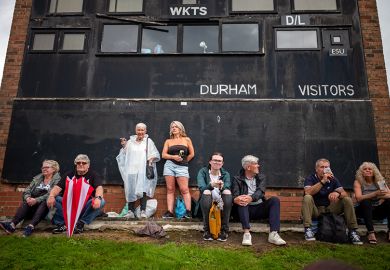 People sit next to a cricket scoreboard as they attend the Durham Miners Gala in Durham, England. To illustrate that elite universities face a ‘balancing act’ over local students.