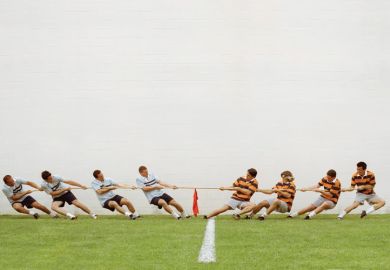 Eight men in tug of war battle