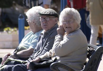 Elderly man and women sitting on bench