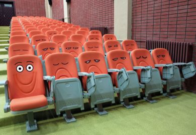 Emotive faces drawn on lecture hall chairs