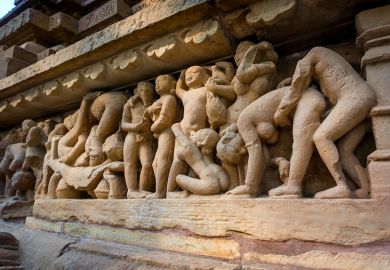 Erotic scene on sculptured surface of famous indian temple of Khajuraho