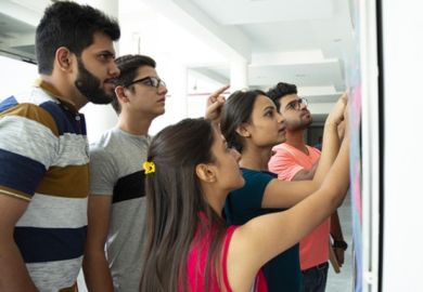 Indian students look at their exam results