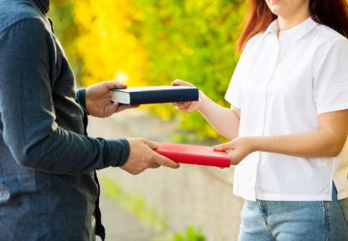 Man and woman exchanging books Man and woman exchanging books as a metaphor for concerns over donor influence in higher education philanthropy
