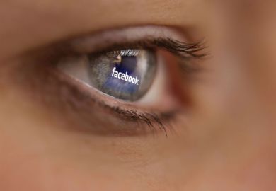 Reflection of Facebook logo on person's eye Reflection of Facebook logo on person's eye