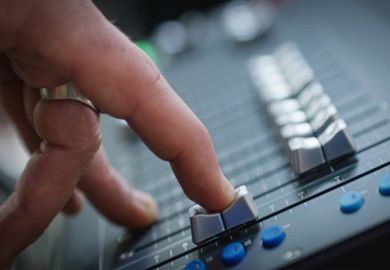 A finger slides down a fader on a mixing desk A finger slides down a fader on a mixing desk, illustrating the fading out of music scholarship