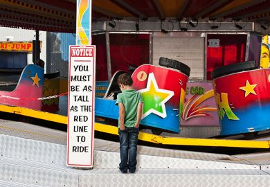 Fairground waltzers ride with minimum height safety notice and disappointed child. To illustrate minimum entry standards. Fairground waltzers ride with minimum height safety notice and disappointed child. To illustrate minimum entry standards.