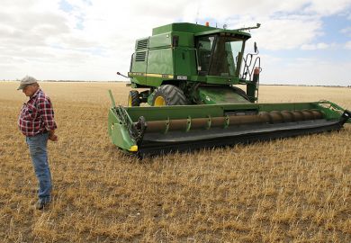 Farmer and machine in field