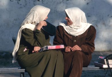 Female students chatting on bench