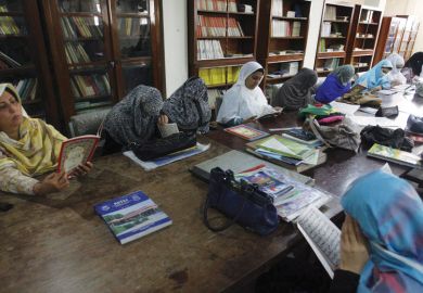 Female students reading in Peshawar University library Female students reading in Peshawar University library