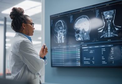 A female doctor looks at an MRI image