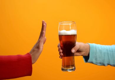 Female rejecting beer glass showing stop gesture Female rejecting beer glass showing stop gesture